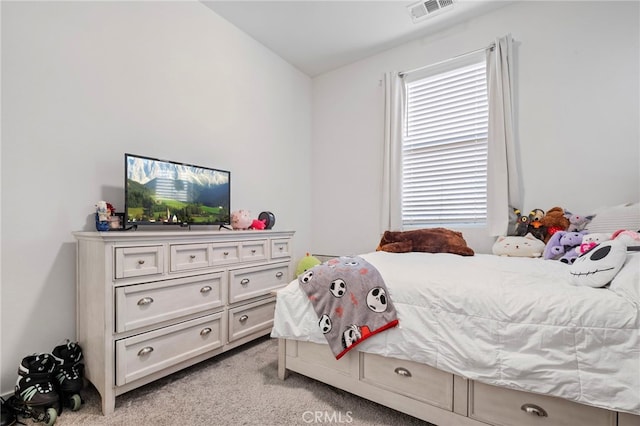bedroom featuring light colored carpet and visible vents