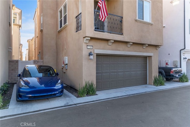 view of side of property featuring stucco siding and a garage