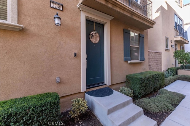 entrance to property featuring stucco siding