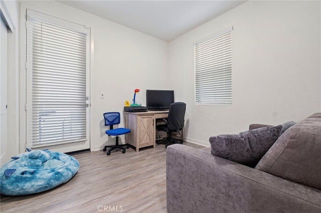 home office featuring baseboards and light wood-style flooring