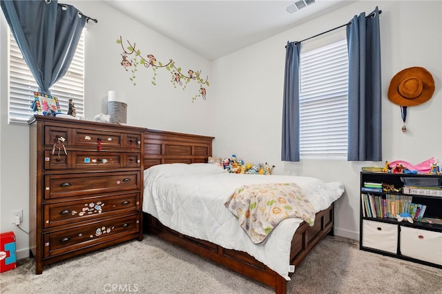 carpeted bedroom featuring multiple windows, visible vents, and baseboards
