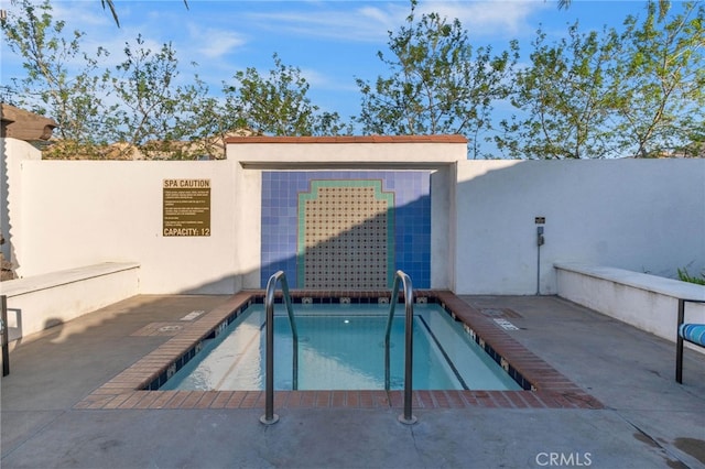 view of swimming pool featuring a pool and fence