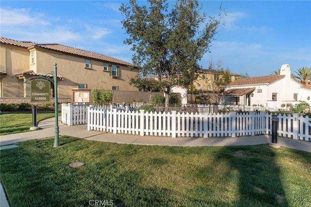 exterior space featuring a yard, stucco siding, and fence private yard