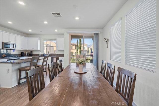 dining room featuring visible vents, wood finished floors, and recessed lighting