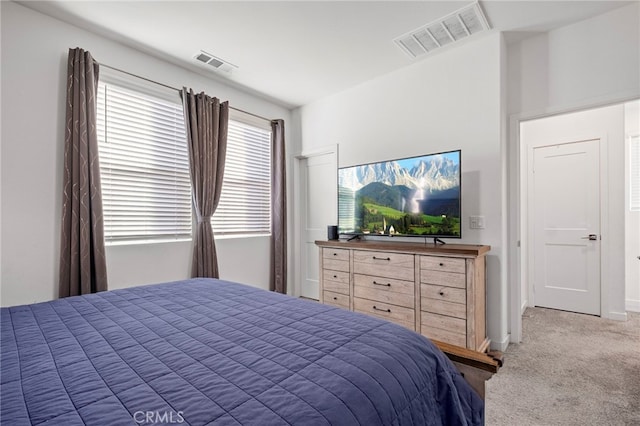 carpeted bedroom featuring baseboards and visible vents