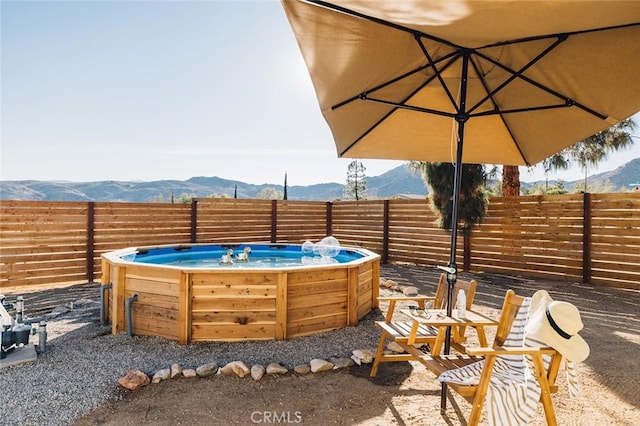 4883 Avenida La Candela, Joshua Tree, CA 92252 - fenced backyard featuring a hot tub and a mountain view