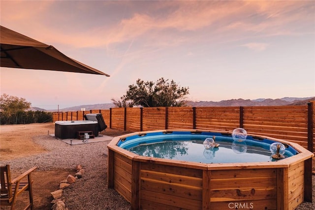 4883 Avenida La Candela, Joshua Tree, CA 92252 - view of swimming pool featuring a hot tub and a mountain view