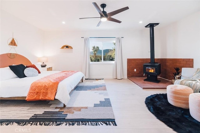4883 Avenida La Candela, Joshua Tree, CA 92252 - bedroom with wood finished floors, a wood stove, and recessed lighting
