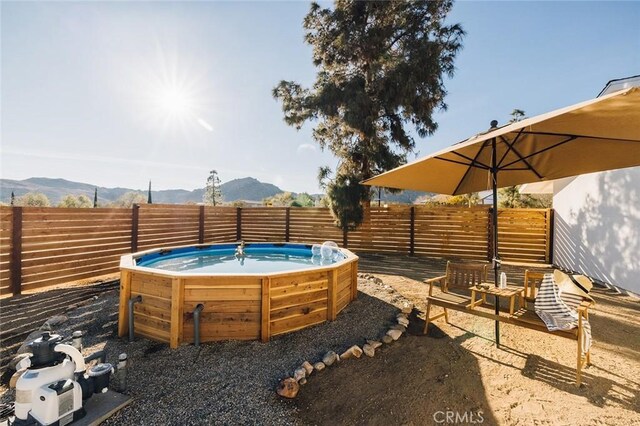 4883 Avenida La Candela, Joshua Tree, CA 92252 - fenced backyard featuring a mountain view and a hot tub