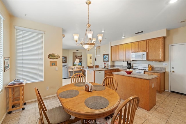 dining room with baseboards, light tile patterned flooring, visible vents, and an inviting chandelier