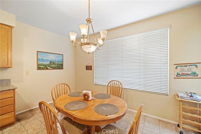 dining room featuring light tile patterned floors, baseboards, and an inviting chandelier