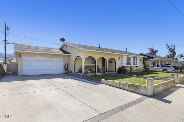 single story home featuring a garage, concrete driveway, fence, a front lawn, and stucco siding