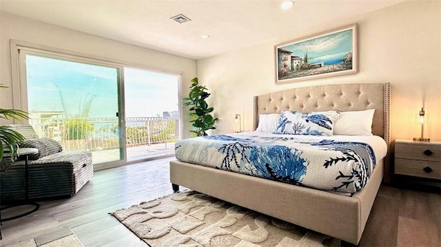 bedroom with access to exterior, recessed lighting, visible vents, and wood finished floors