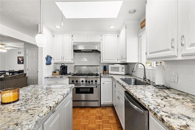 kitchen featuring a sink, stainless steel appliances, under cabinet range hood, and white cabinetry