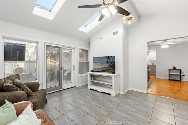 tiled living room featuring visible vents, beamed ceiling, high vaulted ceiling, baseboards, and ceiling fan