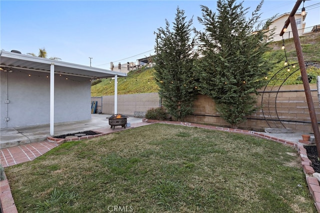 view of yard featuring a patio area, an outdoor fire pit, and a fenced backyard