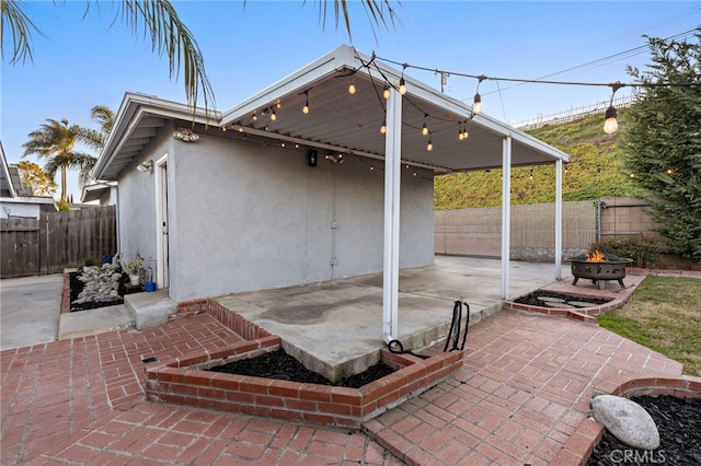 view of patio featuring a fire pit and fence private yard