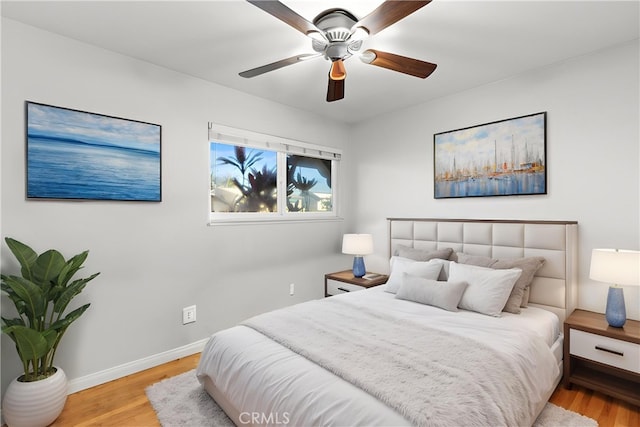 bedroom with wood finished floors, baseboards, and ceiling fan