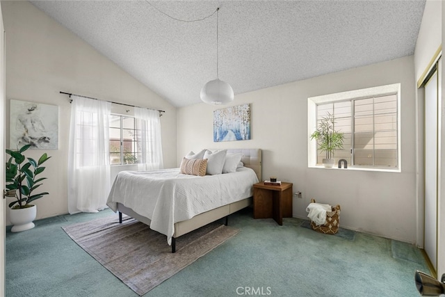 carpeted bedroom with lofted ceiling and a textured ceiling