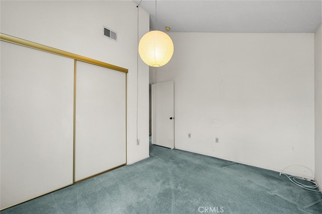 unfurnished bedroom featuring high vaulted ceiling, a closet, carpet, and visible vents