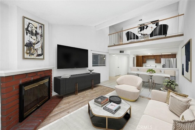 1694 Bridgeport, West Covina, CA 91791 - living room featuring a fireplace, light wood-style floors, beam ceiling, and high vaulted ceiling
