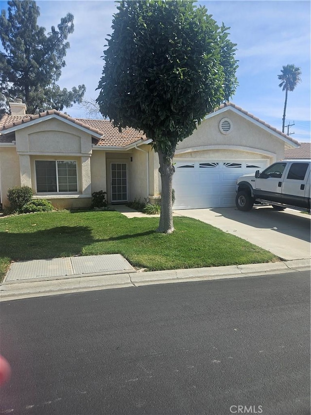 single story home with an attached garage, driveway, a tiled roof, stucco siding, and a front yard