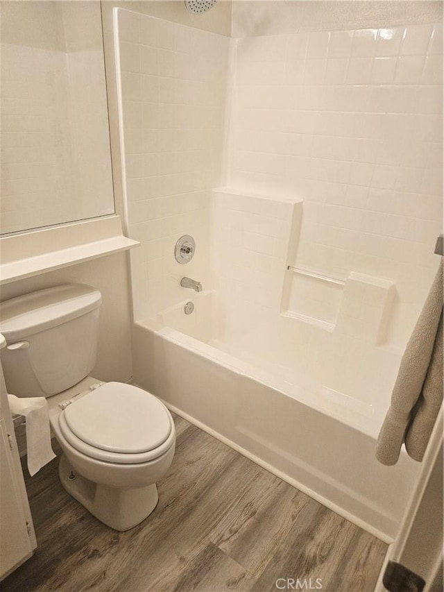 full bathroom with shower / bathtub combination, wood finished floors, and toilet