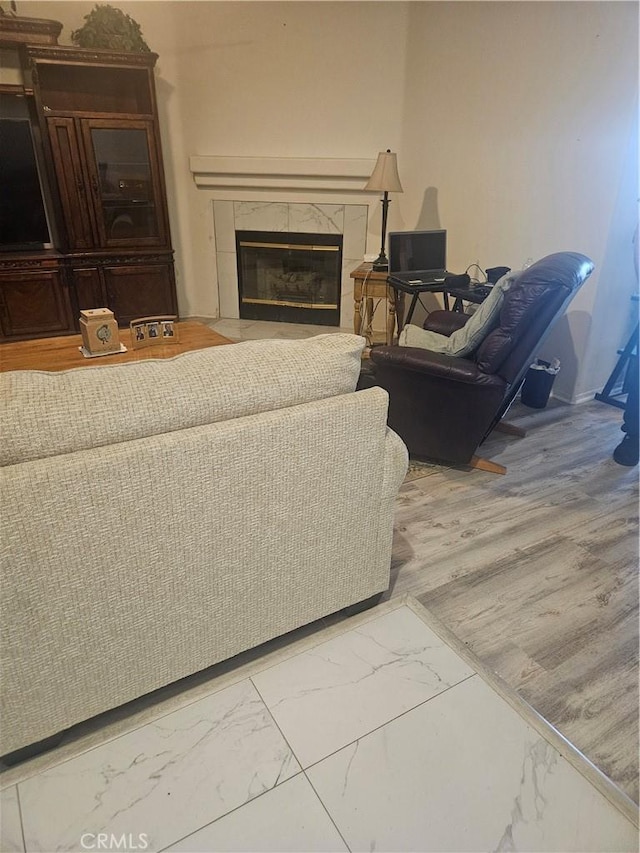 living room with marble finish floor and a premium fireplace