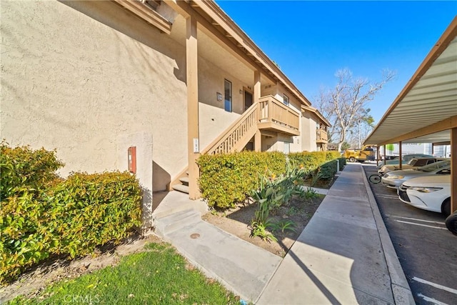 surrounding community with covered parking and stairs