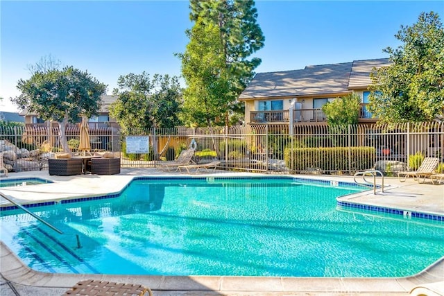 pool featuring fence and a patio