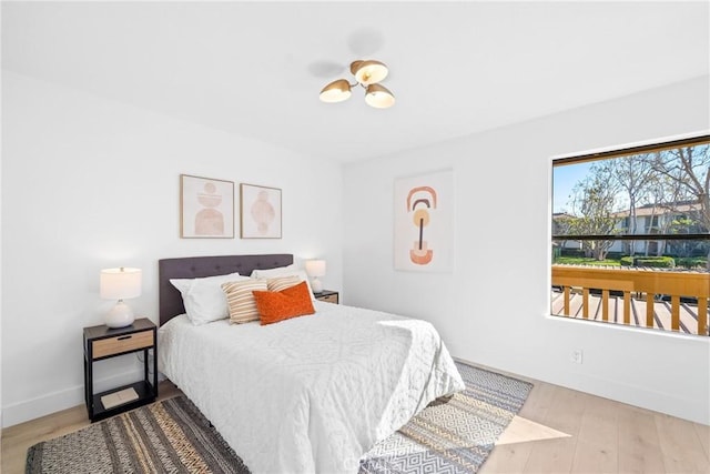 bedroom with baseboards and wood finished floors