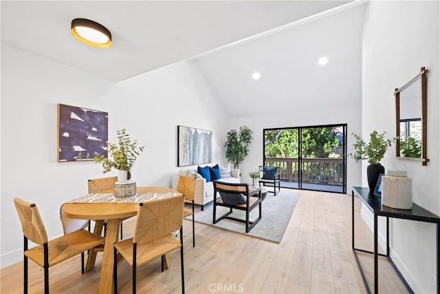 dining area featuring high vaulted ceiling, recessed lighting, light wood-style flooring, and baseboards