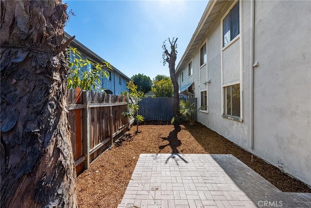 view of yard featuring fence private yard and a patio area