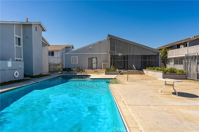 pool featuring a patio area and fence