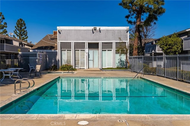 pool featuring fence and a patio