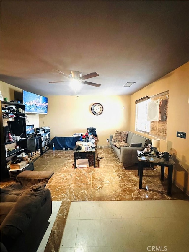 living area featuring a ceiling fan