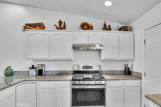 kitchen featuring under cabinet range hood, white cabinetry, recessed lighting, stainless steel range with gas stovetop, and vaulted ceiling