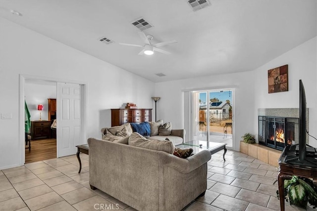 living area with visible vents, a fireplace, and a ceiling fan