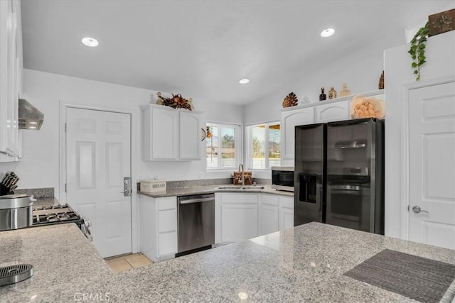 kitchen with ventilation hood, light tile patterned flooring, a sink, stainless steel appliances, and white cabinetry