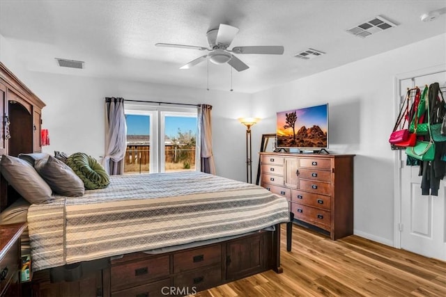 bedroom featuring visible vents, ceiling fan, and light wood finished floors