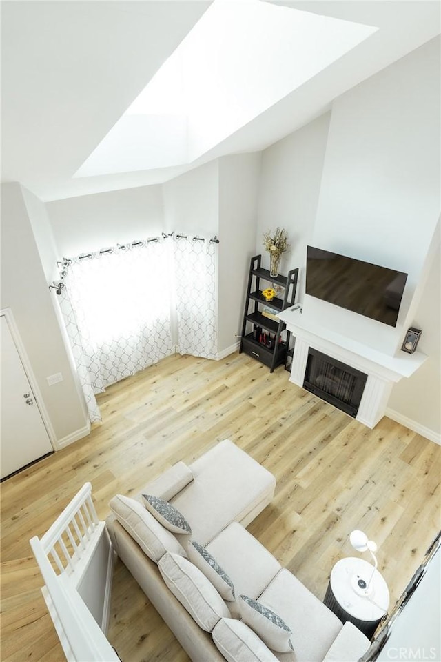 living area featuring baseboards and wood finished floors