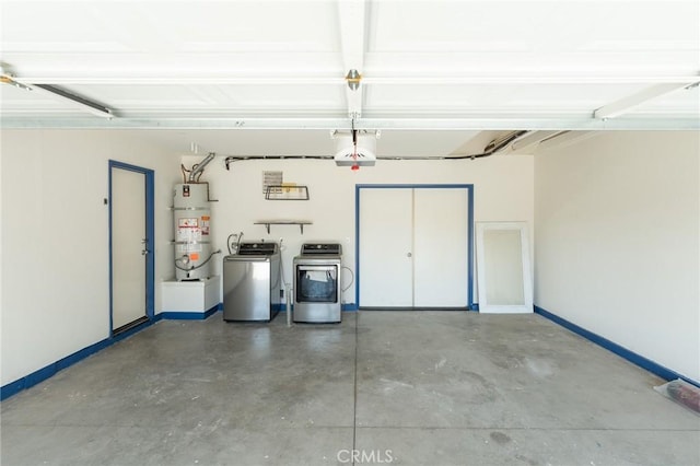 garage with secured water heater, baseboards, and separate washer and dryer