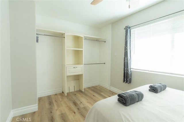 bedroom featuring baseboards, ceiling fan, and light wood finished floors