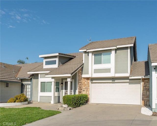 view of front of house featuring a garage, stone siding, and concrete driveway