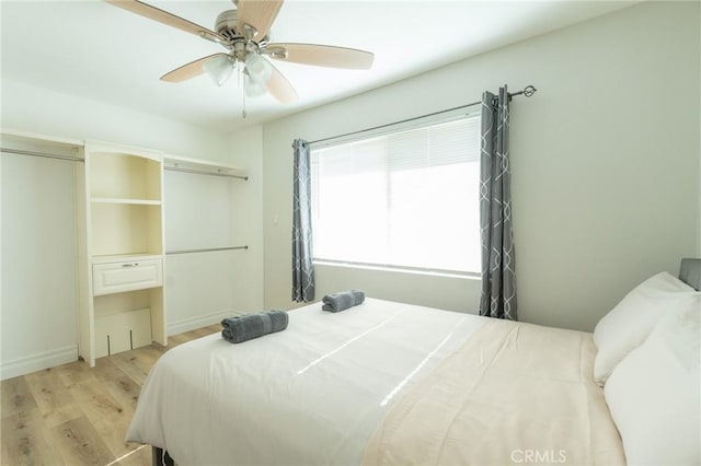 bedroom with light wood-type flooring and ceiling fan