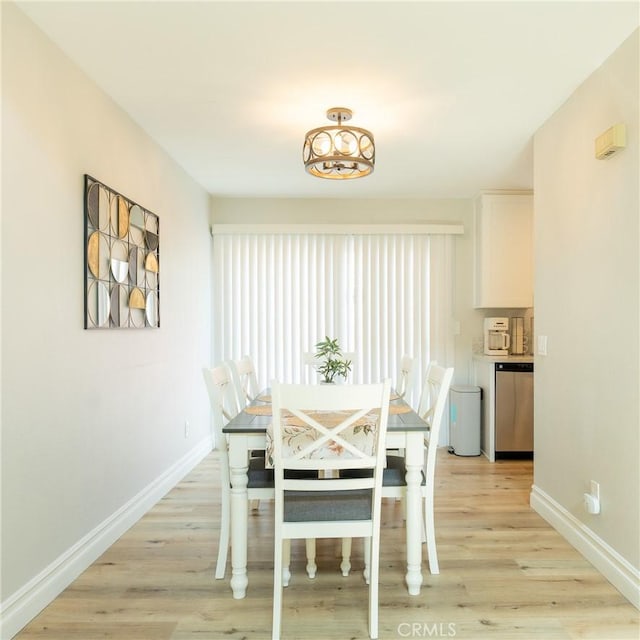 unfurnished dining area with baseboards and light wood finished floors