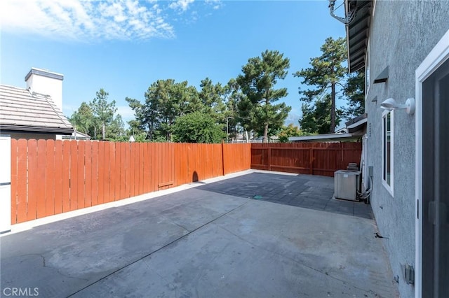 view of patio / terrace featuring cooling unit and a fenced backyard