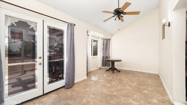 spare room featuring lofted ceiling, baseboards, a ceiling fan, and french doors