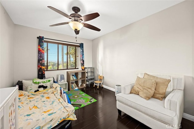 bedroom with dark wood-type flooring, baseboards, and a ceiling fan