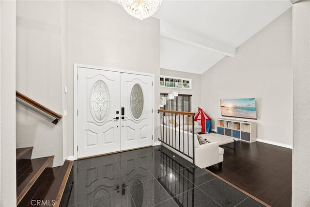 entrance foyer featuring baseboards, stairway, an inviting chandelier, high vaulted ceiling, and beam ceiling